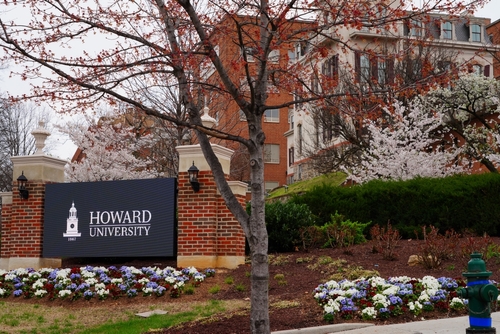 Photo of Howard campus featuring Howard sign and flowers